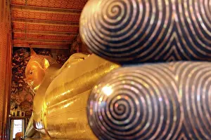 Statues: Giant gold reclining Buddha statue at Wat Pho Temple in Bangkok, Thailand
