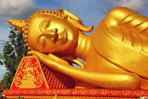Golden: Giant gold reclining sleeping Buddha statue near Wat That Luang Temple, Vientiane, Laos