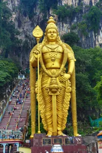 Religious: Giant golden statue of the god Murugan at the entrance of the Batu Caves