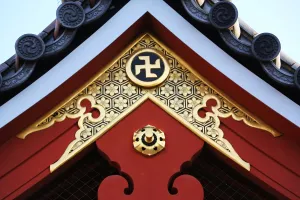 Symbols: Gold Buddhist cross symbol on a roof at the Sensoji Asakusa Kannon Temple, Tokyo, Japan