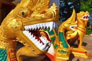 Golden: Gold Naga statue with teeth near Wat That Luang Temple, Vientiane, Laos