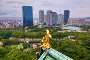 Osaka, Japan: Golden fish roof decoration on Osaka Castle and city skyline, Osaka, Japan