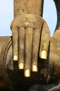 Ruins: Hand on a Buddha statue, Wat Mahathat temple, Sukhotai, Thailand