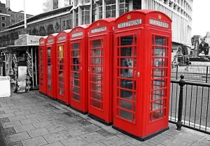 Communication: Line of red telephone boxes in London, England, spot colour