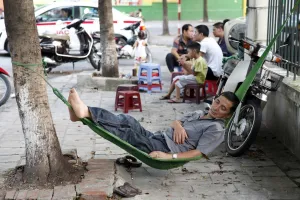 Tired: Man in a hammock in Hanoi, Vietnam