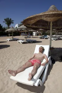 Vacation: Man sunbathing on the beach