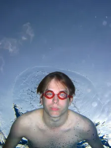 Swimmer: Man swimming underwater wearing goggles