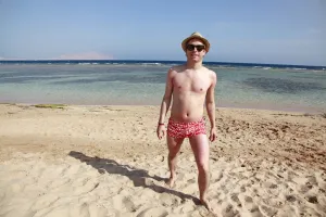 Child: Man walking along the beach