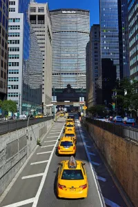 Taxis: MetLife Building and yellow taxi cabs, New York. America