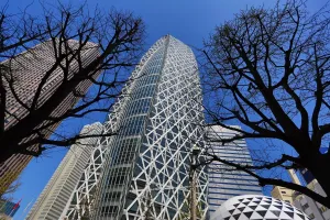 Modern: Mode Gakuen Cocoon Tower building and silhouettes of trees in Tokyo, Japan