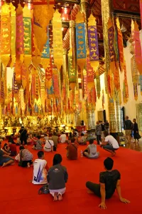 Chiang Mai: New Year banners and gold Buddha statue inside the Wat Chedi Luang Temple during Songkran in Chiang Mai