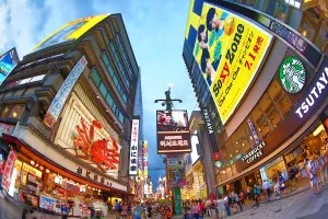 Adverts: Night scene of illuminations and neon lights on buildings and shops and Kani Doraku