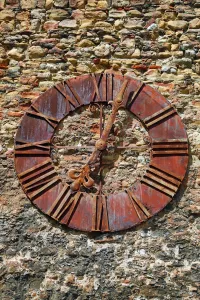 Wall: Old rusty clock on the wall beside Zagreb Cathedral in Zagreb, Croatia