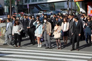 Roads: People waiting at a pedestrain crossing to cross a road in Shinjuku, Tokyo, Japan