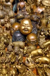 Heads: Pile of brass figures including laughing Buddha head in the Old City, Shanghai, China