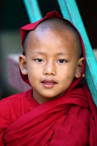 Mandalay, Myanmar: Portrait of a young Buddhist monk playing at a temple in Amarapura, Mandalay, Myanmar
