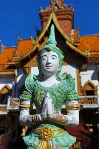 Hall: Praying statue in front of the ordination hall at Wat Buppharam Temple in Chiang Mai