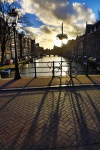 Netherlands: Silhouette of a parked bicycle and its shadow on a bridge over a canal in Amsterdam