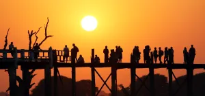 World: Silhouettes on the U Bein Bridge st sunset, Amarapura, Myanmar