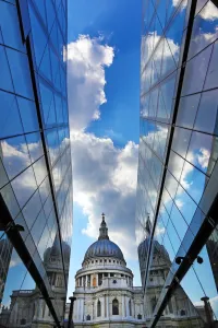 Saint: St Pauls Cathedral and reflection of clouds in glass of One New Change, London, England