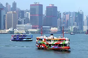 Prints of Two Star Ferries crossing Victoria Harbour with the city skyline in Hong Kong, China Hong Kong Images: Two Star Ferries crossing Victoria Harbour with the city skyline in Hong Kong, China