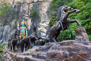 Religious: Statue of Krishna with a horse drawn chariot at the Ramayana Cave at the Batu Caves