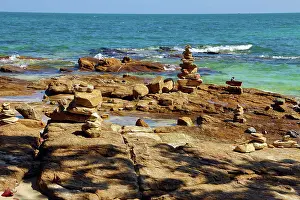 Scene: Stone cairns built on rocks at Tubtim beach on Koh Samet island, Thailand