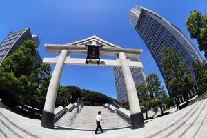 Tokyo, Japan: Stone Torii gate and office buildings outside the Hie-Jinja Shinto Shrine, Tokyo, Japan