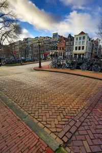 Street scene with bicycles on a bridge over a canal in Herengracht in Amsterdam, Holland
