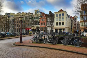 Netherlands: Street scene with bicycles on a bridge over a canal in Herengracht in Amsterdam, Holland