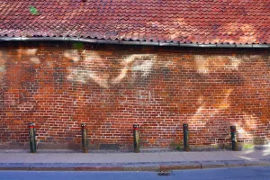 Bricks: Street scene with old brick wall with light reflection in Copenhagen, Denmark