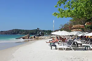 Scene: Sun beds and umbrellas on Sai Kaew Beach on Koh Samet island, Thailand