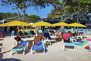 Scene: Sun beds and umbrellas on Sai Kaew Beach on Koh Samet island, Thailand