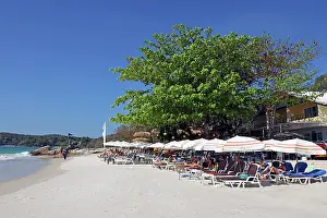 Scene: Sun beds and umbrellas on Sai Kaew Beach on Koh Samet island, Thailand