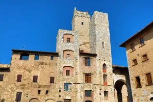 Tower: The Torre Grossa and buildings in the Piazza Cisterno in San Gimignano, Tuscany, Italy