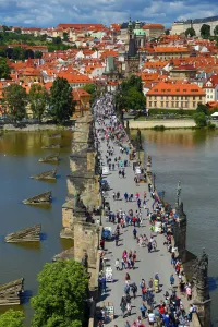Crowds: Tourists walking over the Charles Bridge over the Vltava River in Prague, Czech Republic