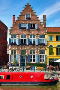 Architecture: Traditional building and houseboat on a canal, Ghent, Belgium