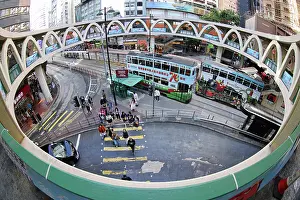 Hong Kong: Traditional Hong Kong electric tram at Yee Wo Street circular pedestrian bridge in Causeway Bay