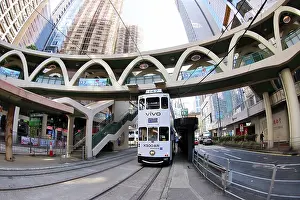 Hong Kong: Traditional Hong Kong electric tram at Yee Wo Street circular pedestrian bridge in Causeway Bay