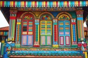 Brightly: Traditional rainbow coloured house with colourful windows and shutters in Little India in Singapore
