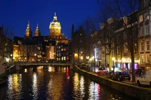 View up the canal in Oudezijds Voorburgwal at night in Amsterdam, Holland