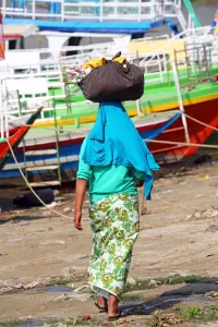 Head: Woman carrying bag on her head in Old Bagan, Bagan, Myanmar (Burma)