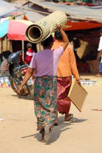 Head: Woman carrying a carpet on her head in Old Bagan, Bagan, Myanmar (Burma)