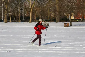 Snow In London: A woman on skis in the snow in St James Park, London