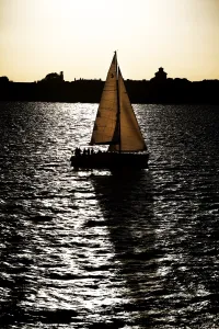 Shadow: Yacht sailing on the sea at sunset