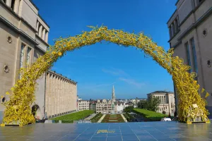 Hall: Yellow Arch of bicycles at the Mont des Arts Gardens and Tower of the Town Hall, Brussels