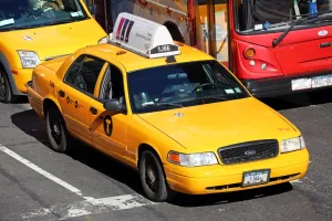 Scene: Yellow taxi cabs driving in the street, New York. America