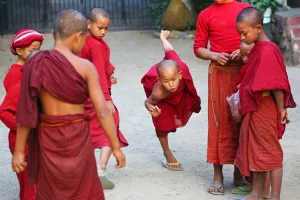 Mandalay, Myanmar: Young Buddhist monks playing at a temple in Amarapura, Mandalay, Myanmar (Burma)