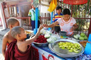 Monastery: Young monks at the Atum Ash Monastery buying food from a street vendor, Mandalay